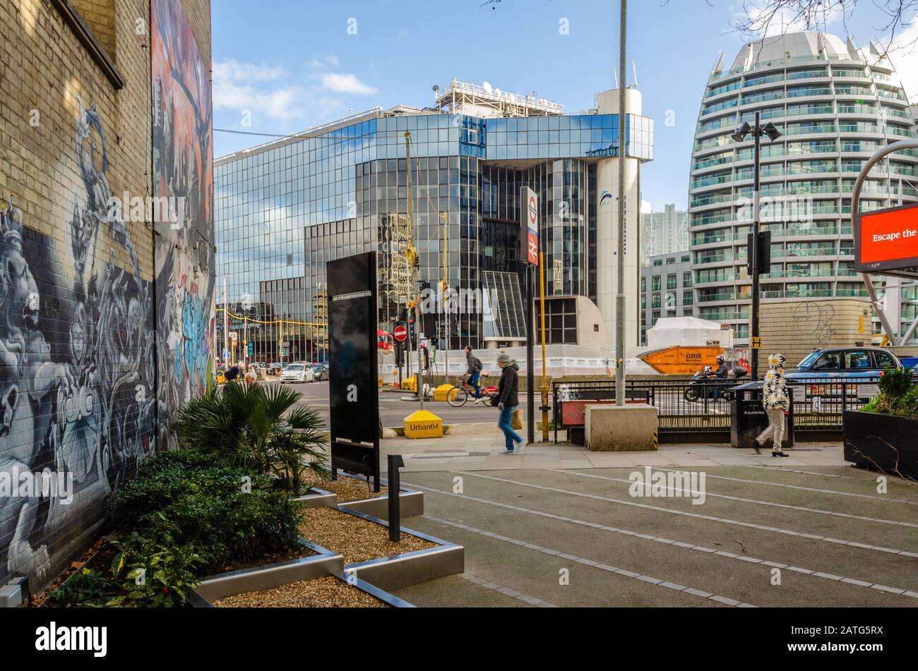 Modern office buildings on The Silicon Roundabout in London. A brick wall is decorated with colourful street art. Stock Photo