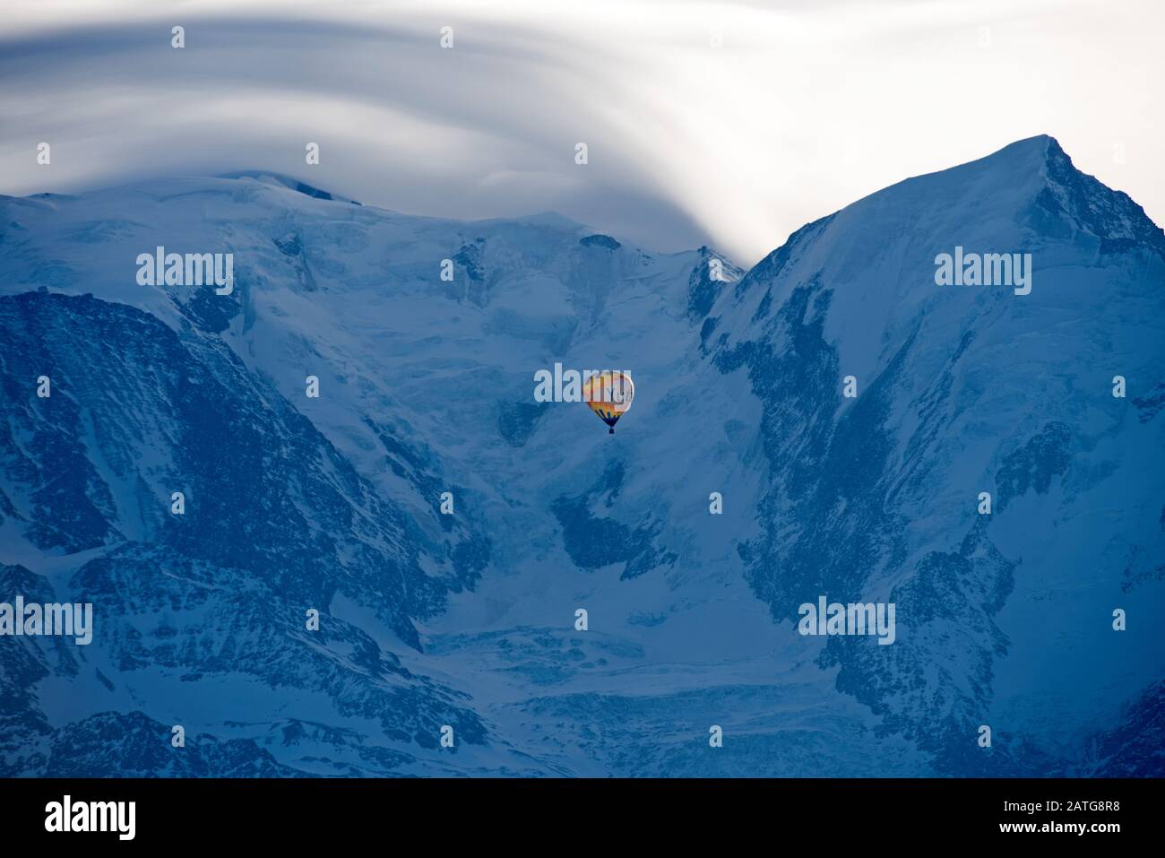 France, Haute-Savoie (74), Alps, Mont Blanc mountain range, lenticular cloud and hot air balloon Stock Photo