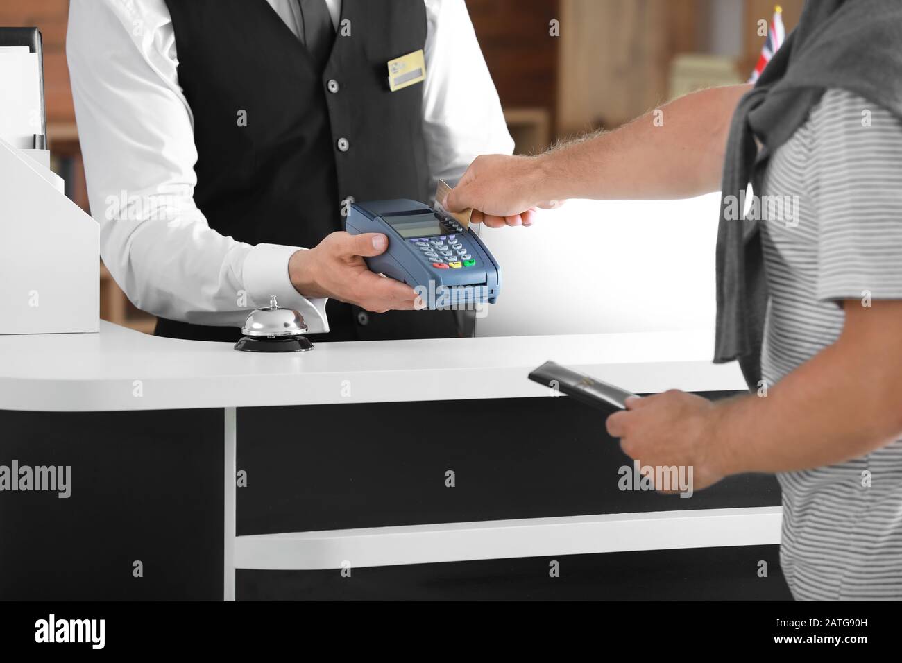 Man paying for hotel room at reception Stock Photo Alamy