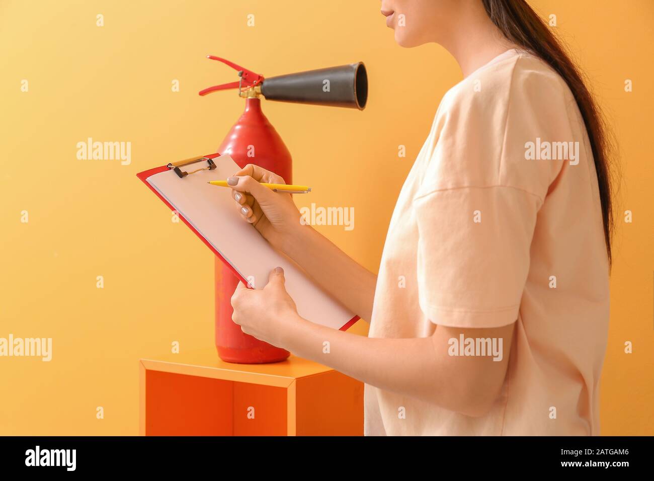 Fire safety specialist inspecting extinguisher Stock Photo