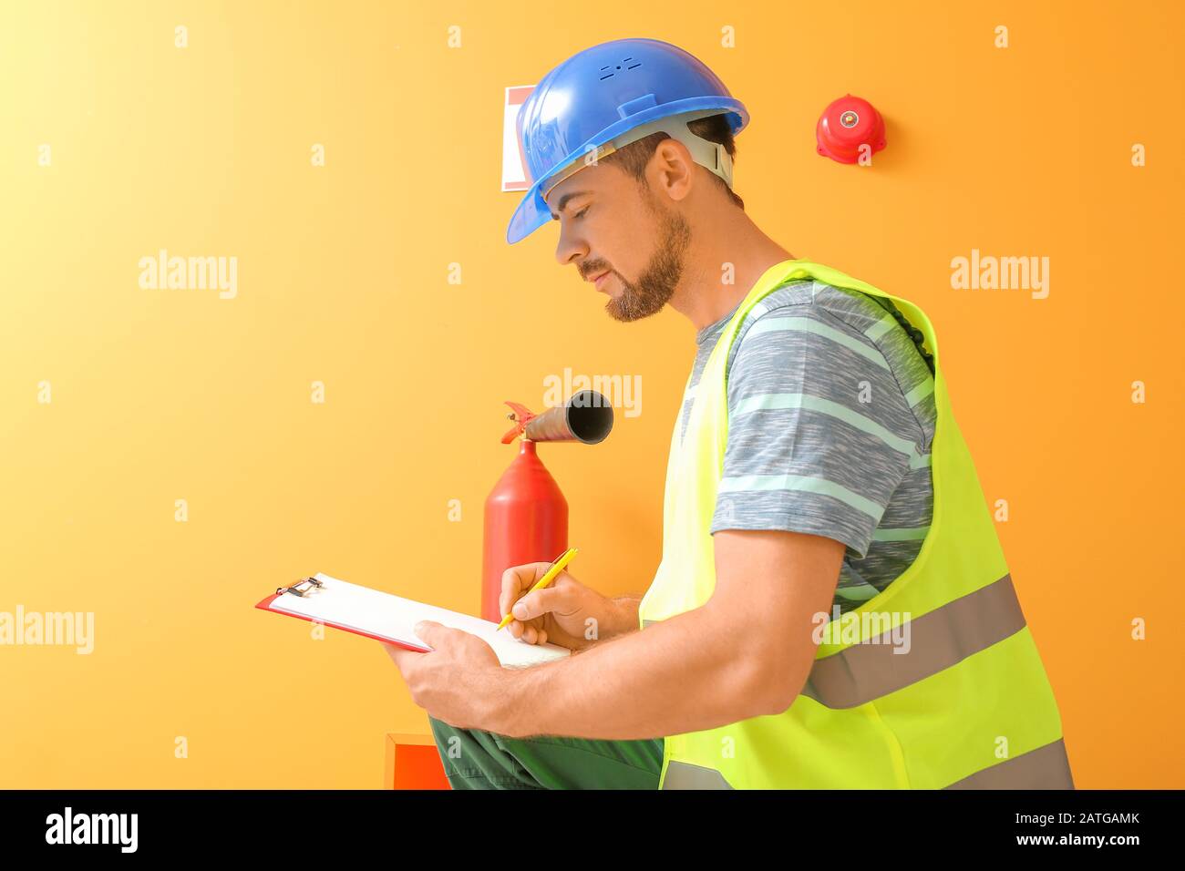 Fire safety specialist inspecting extinguisher Stock Photo Alamy