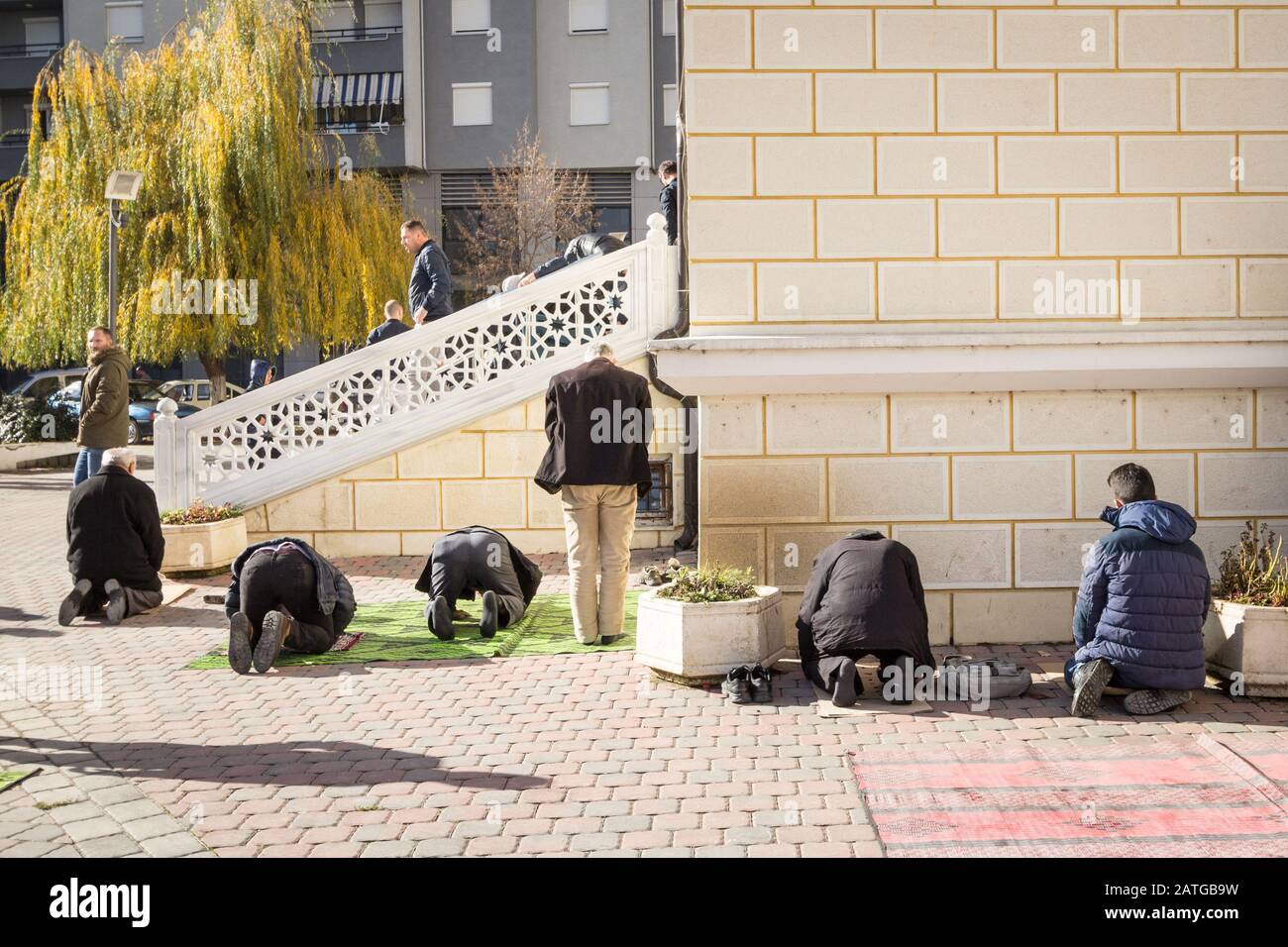 MITROVICA, KOSOVO - NOVEMBER 11, 2016: Kosovo Albanian muslims praying in front of the Isa Beg Mosque, Mitrovica. Isa Beg mosque is an islamic landmar Stock Photo