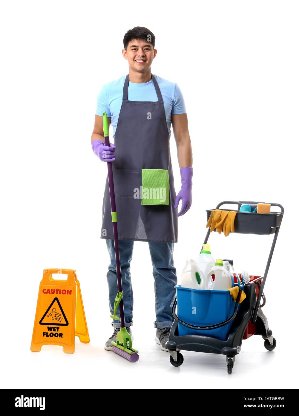 Asian janitor with cleaning supplies on white background Stock Photo