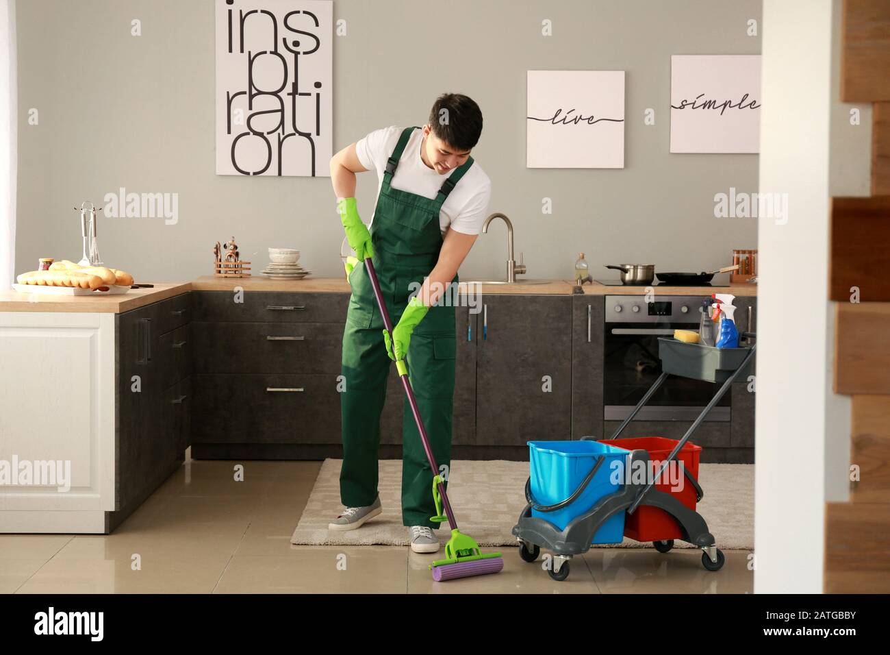 Asian janitor cleaning floor in kitchen Stock Photo Alamy