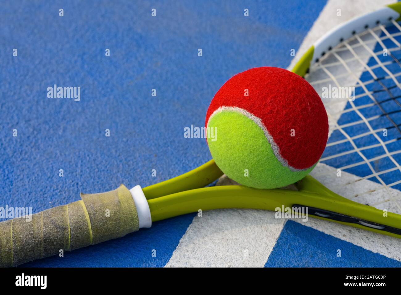 tennis ball and racket in an outdoor court Stock Photo - Alamy