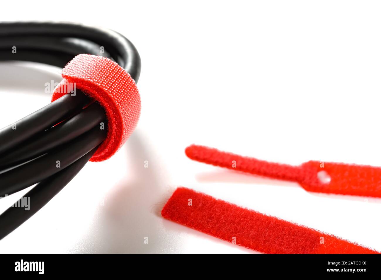 red velcro cable tie and cable on white Stock Photo Alamy