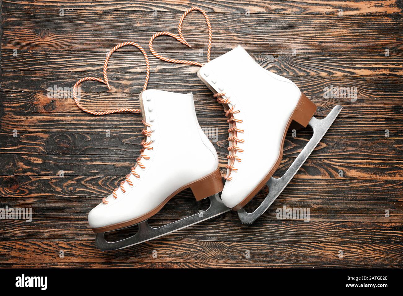 Ice skate shoes on wooden background Stock Photo - Alamy