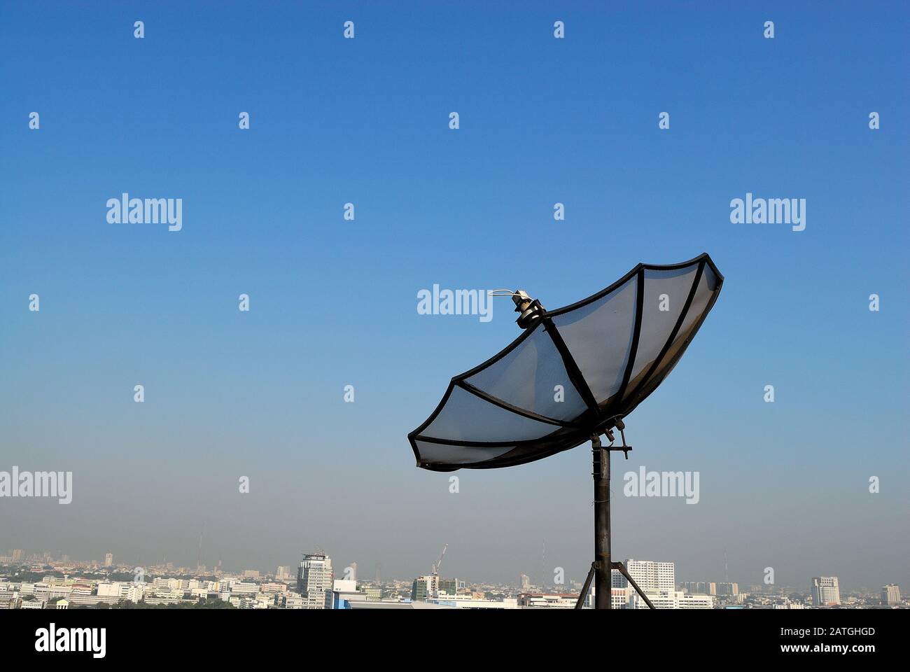 Satellite dish on rooftop installed for receiving signal television and communication technology with beautiful sky background. Stock Photo
