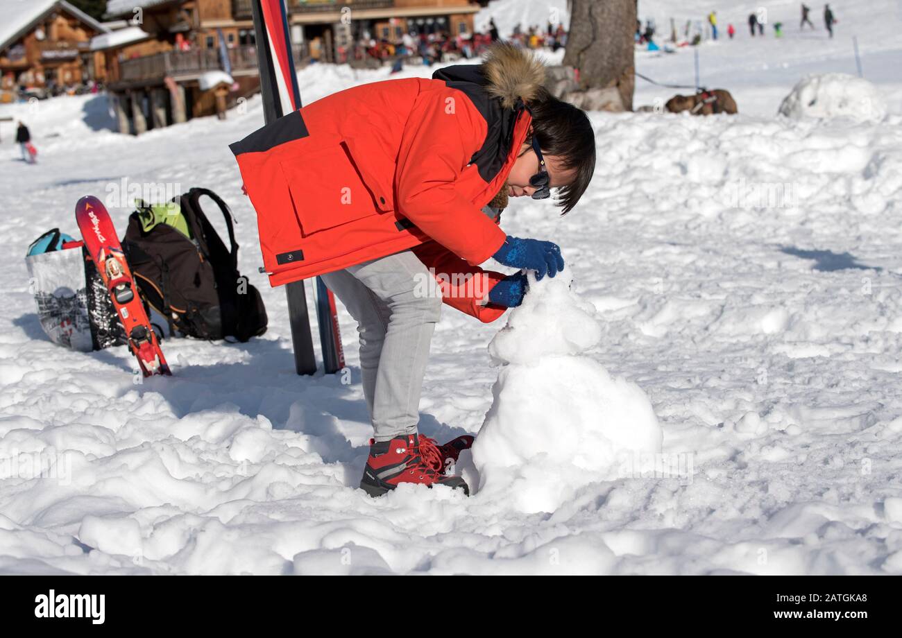 Boy making a snow man Stock Photo