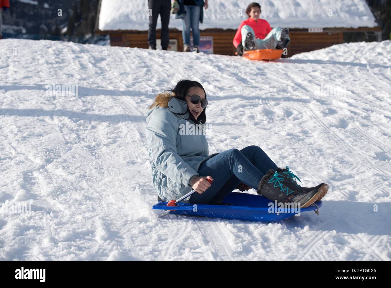 Woman on a sledge, scared Stock Photo