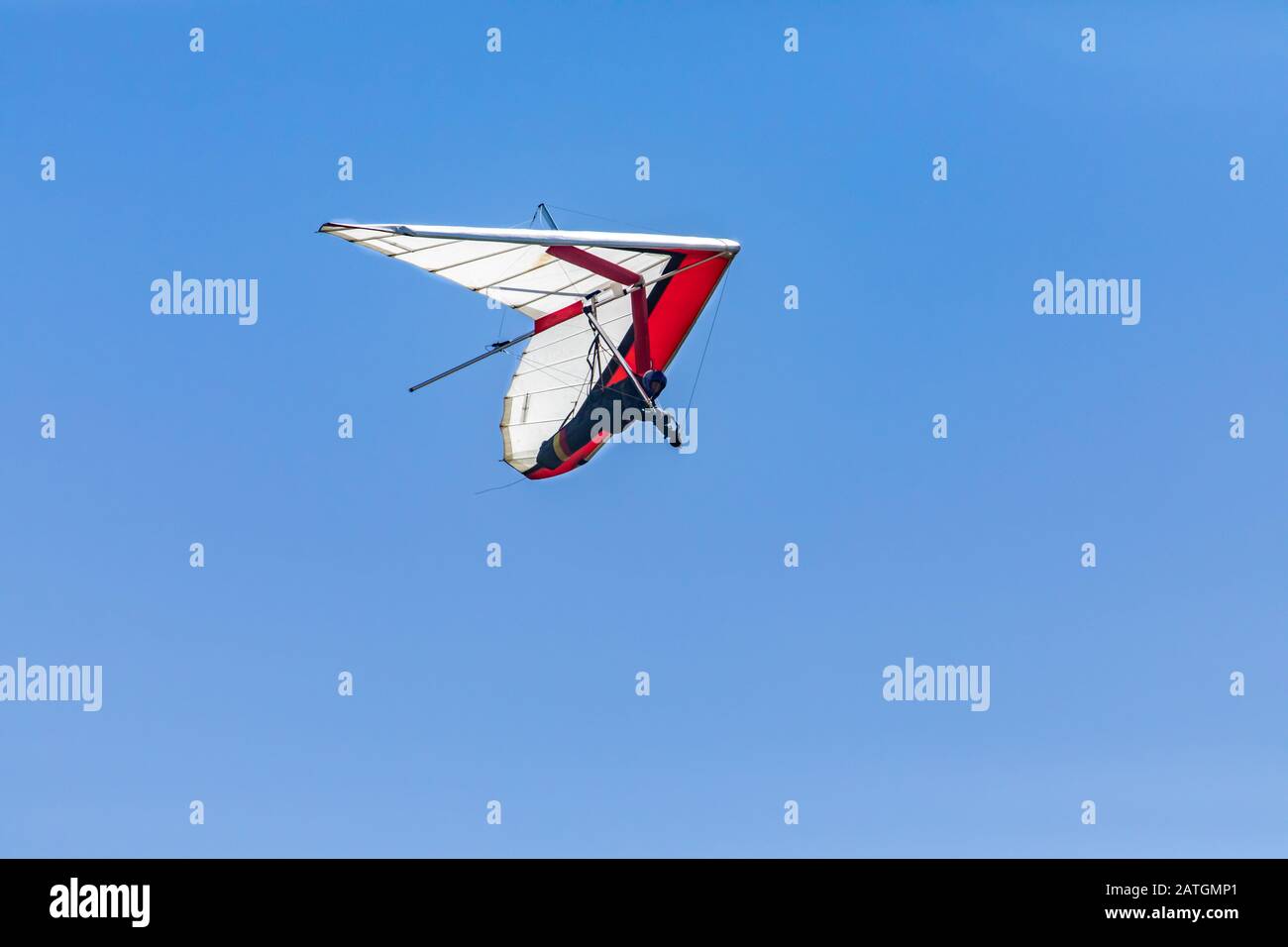 Hangglider flying through the clear blue. Hanggliding competition in