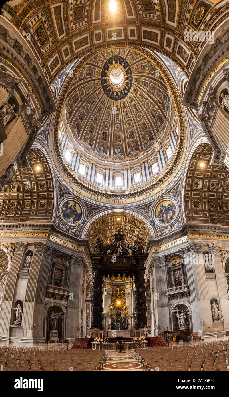 A very wide angle view inside St. Peters basilica looking at the Papal Altar area and Baldacchino beneath the great dome, Vatican City, Rome, Italy Stock Photo