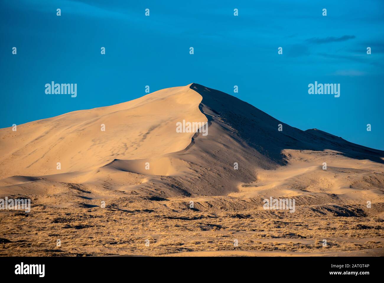 Huge sand dunes located in California's Mojave Desert cast a shadow