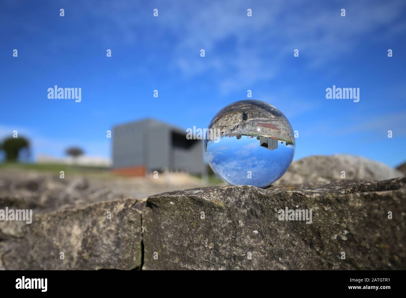 The villa of Veranes is reflected over a glass sphere Stock Photo