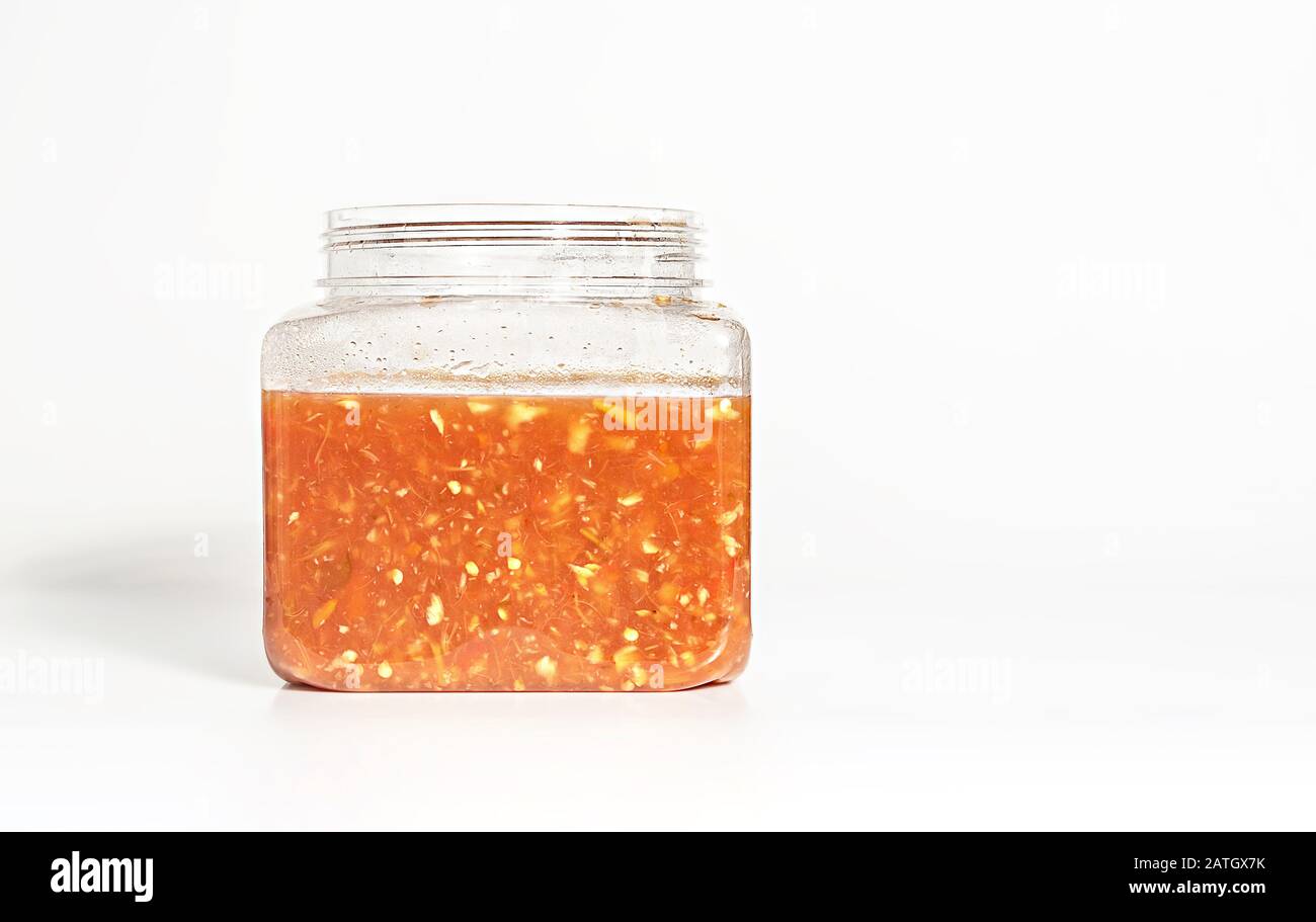 Homemade garlic and chilli sauce in plastic jar , Asian style cuisine