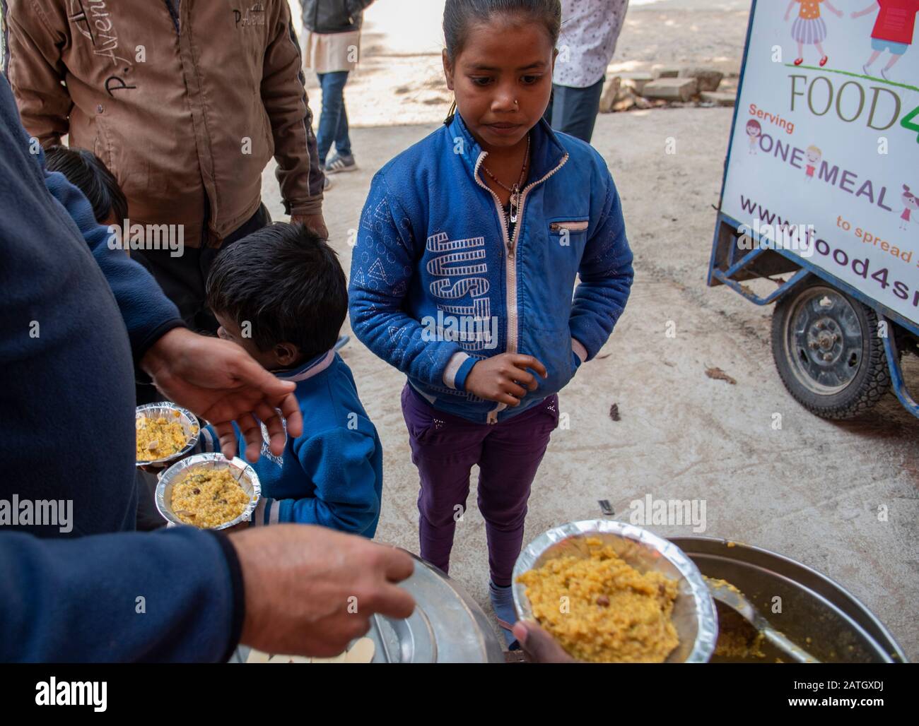 Free distribution of food at a food camp in New Delhi for poor people ...