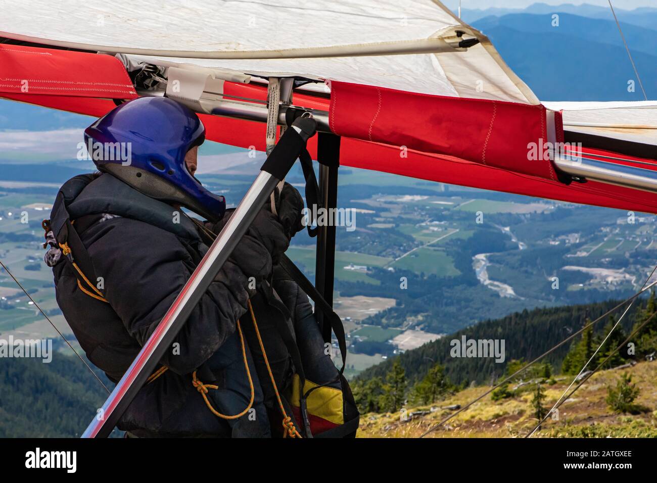 Hangglider pilot in special clothing and gears preparing and checking