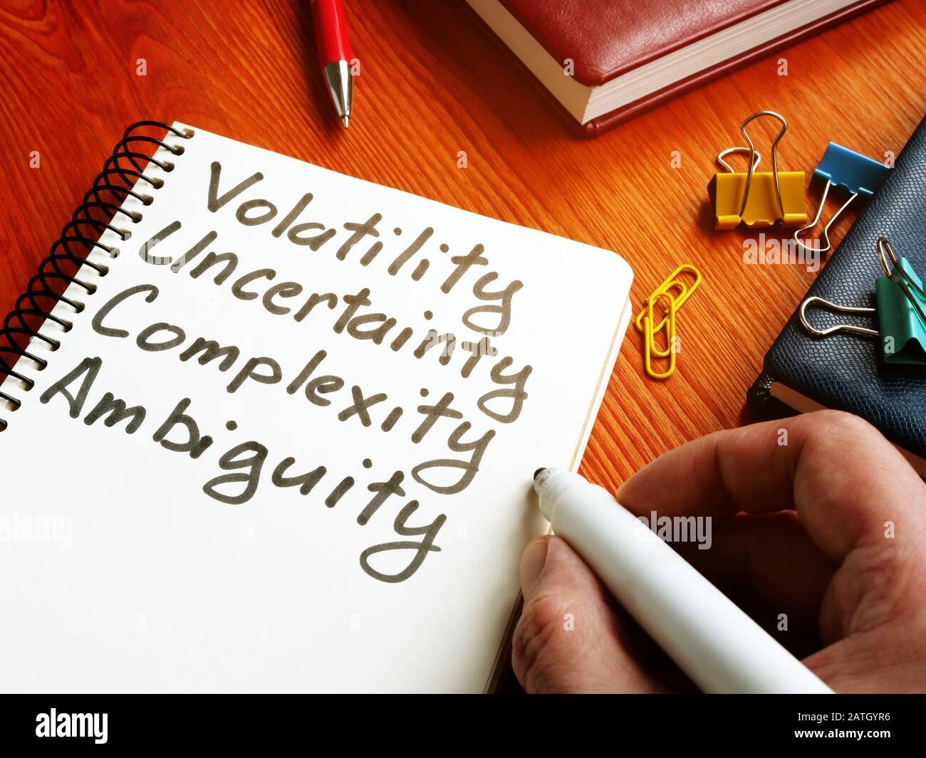 VUCA - Volatility, Uncertainty, Complexity, Ambiguity inscriptions in the note. Stock Photo