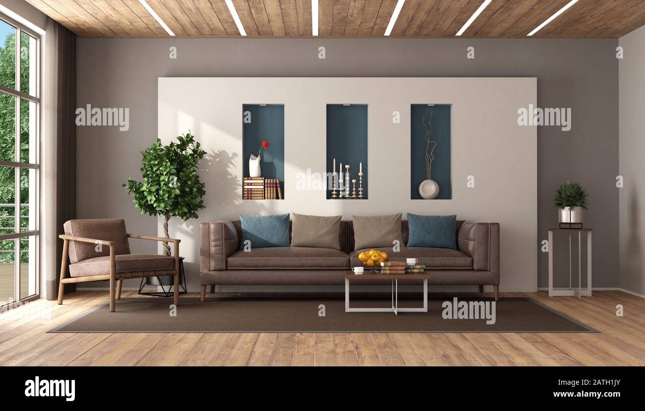 Modern living room with leather sofa and armchair against white wall ...