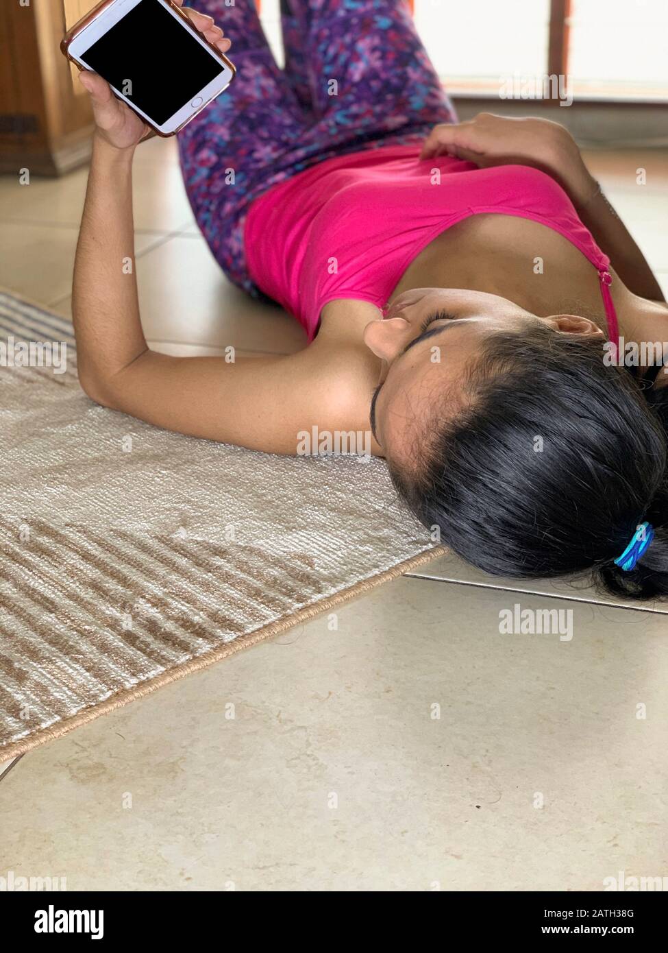 Young latin woman with smartphone at home, Panama, Central America Stock Photo