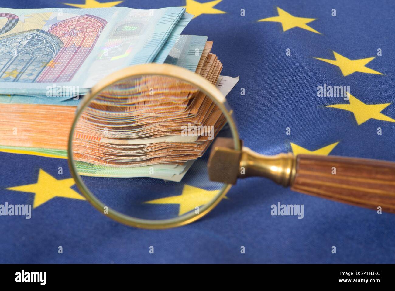 Magnifying glass, European Union flag and euro banknotes Stock Photo