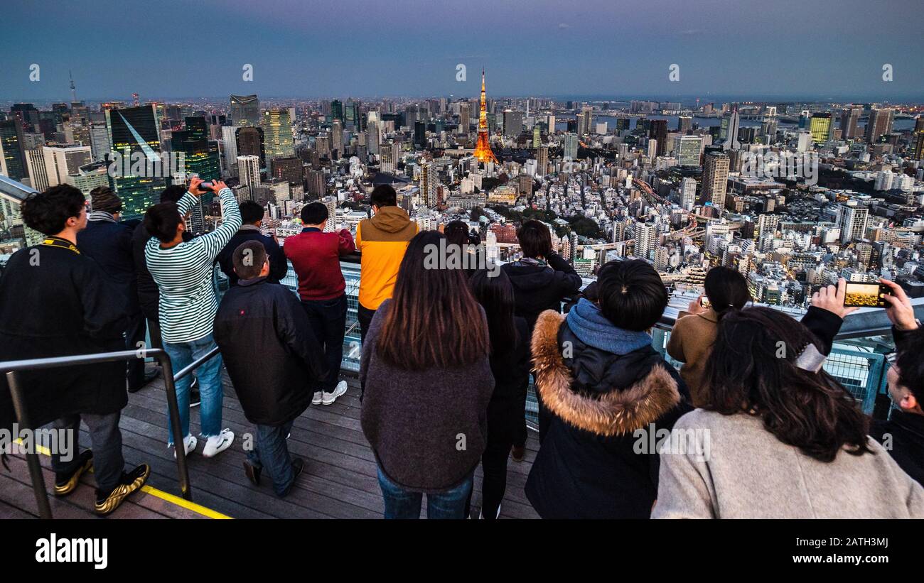 Tokyo Tourists Tokyo Tourism - Tourists view the Tokyo Tower and Greater Tokyo from the Roppongi Hills Observation Deck Tokyo City View Stock Photo