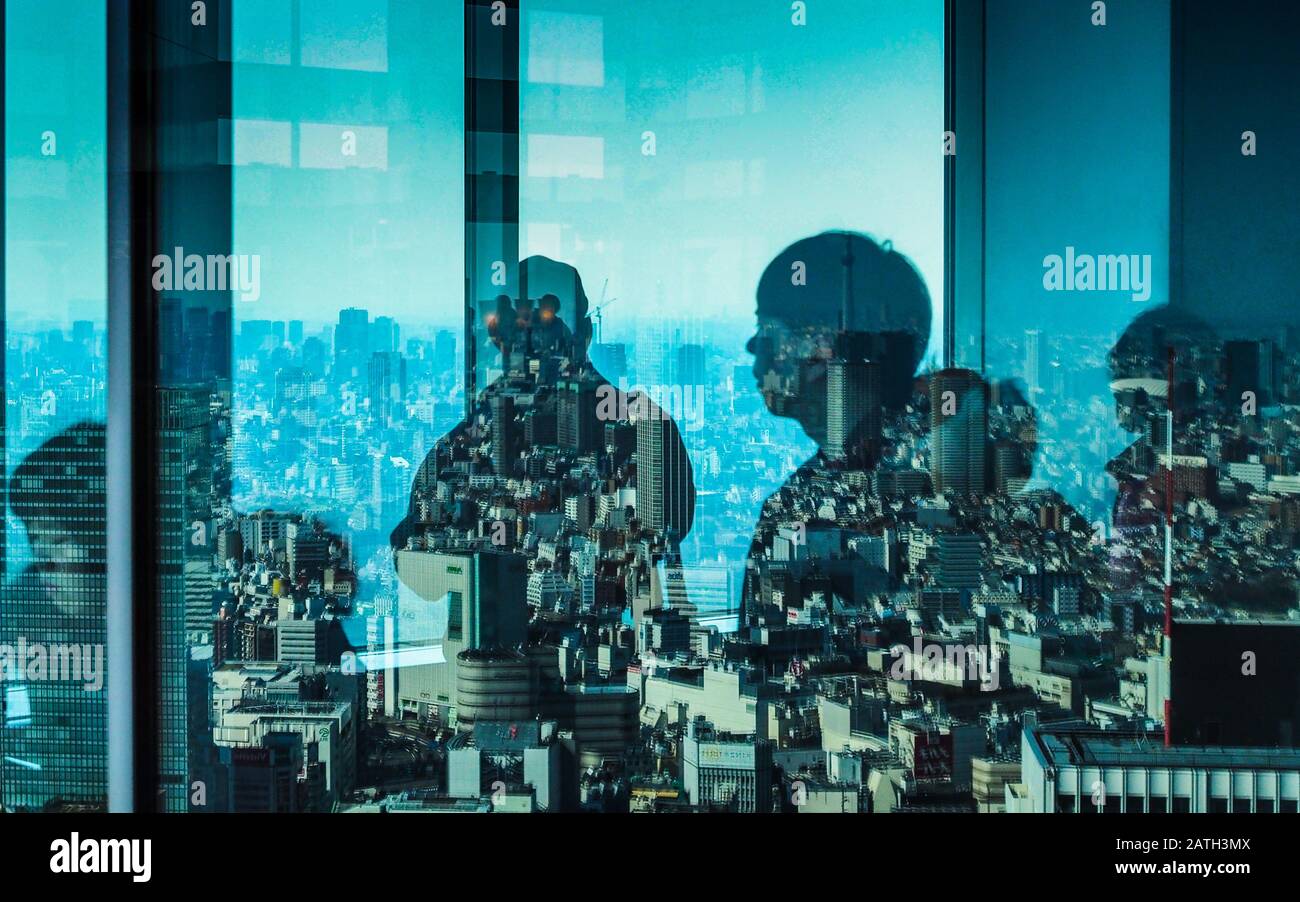 Tokyo - Tourists Viewing Tokyo. Tourists & visitors view Tokyo from the Tokyo Metropolitan Government Building viewing gallery. Tokyo Viewing Gallery Stock Photo