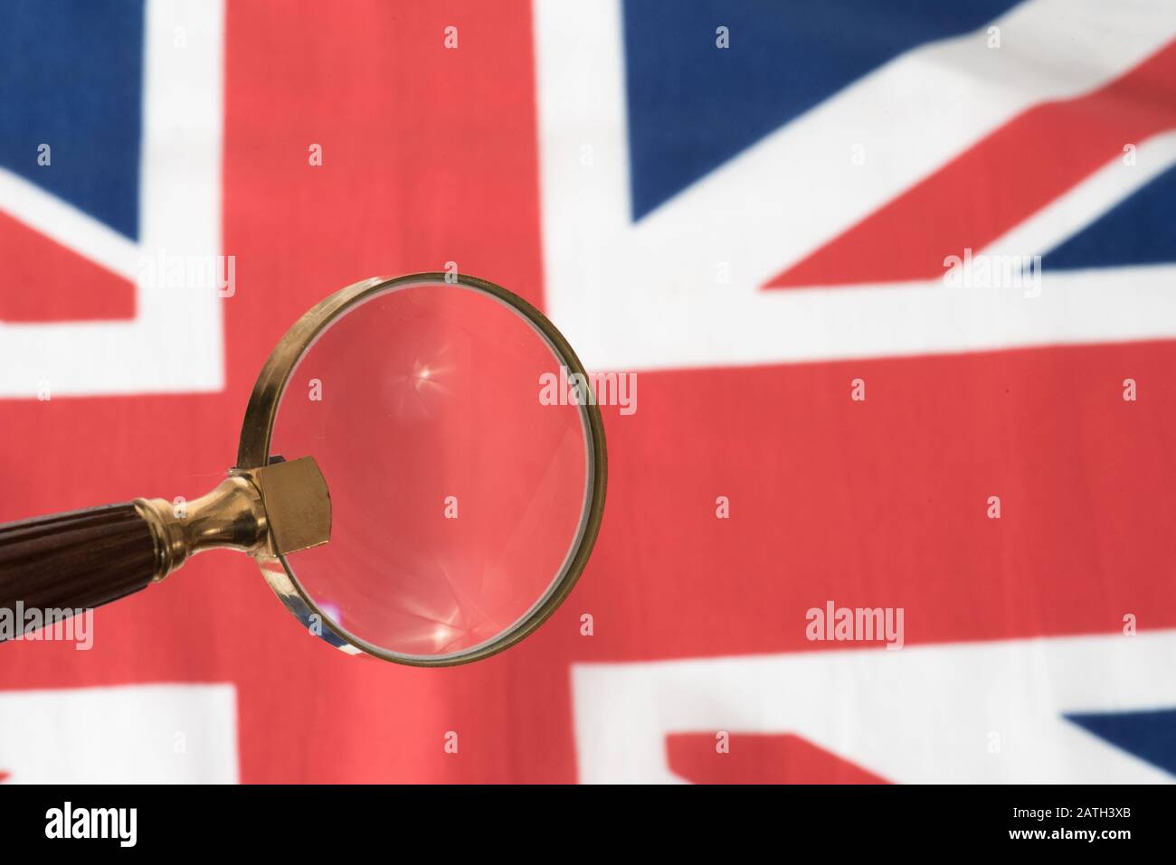 A magnifying glass and the flag of Great Britain Stock Photo