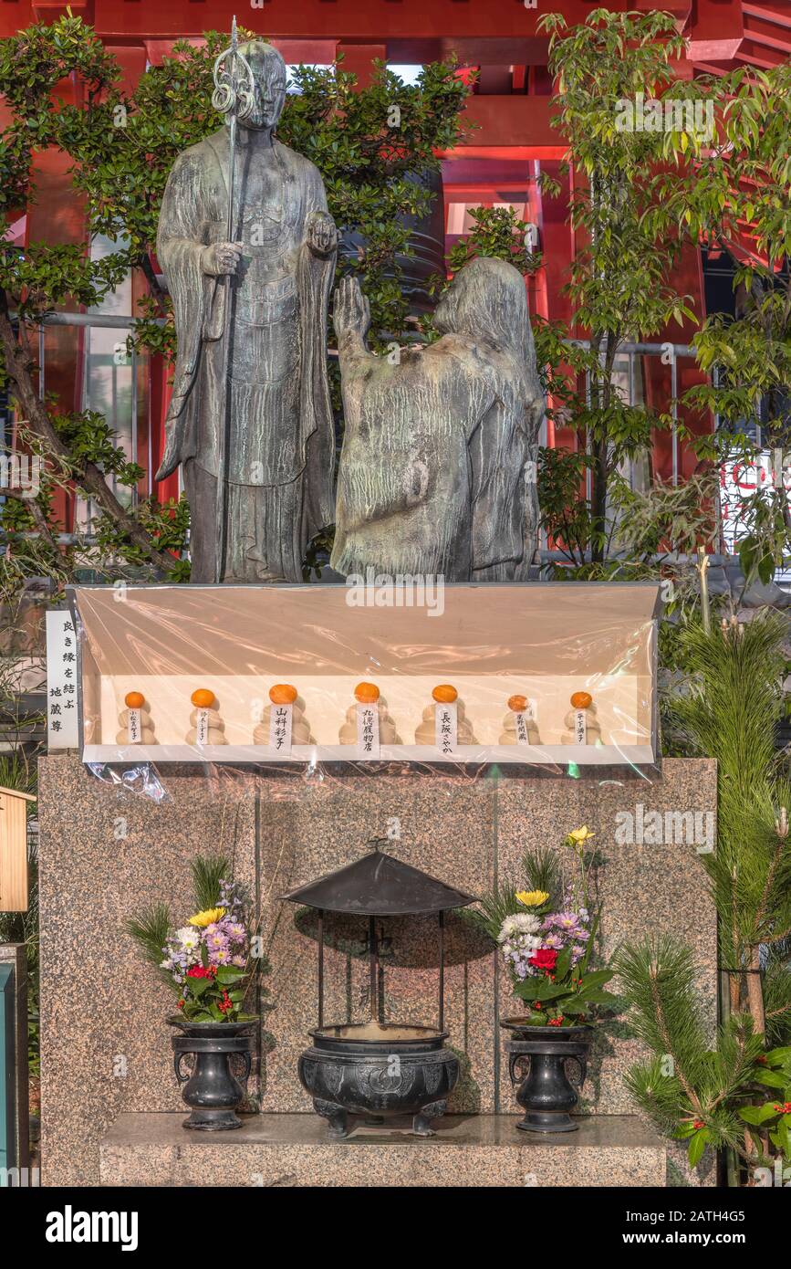 tokyo, japan - january 02 2020: Statue of Jizo Enmusubi who prays that people will find a soul mate and get married in the Tokudaiji temple at night. Stock Photo