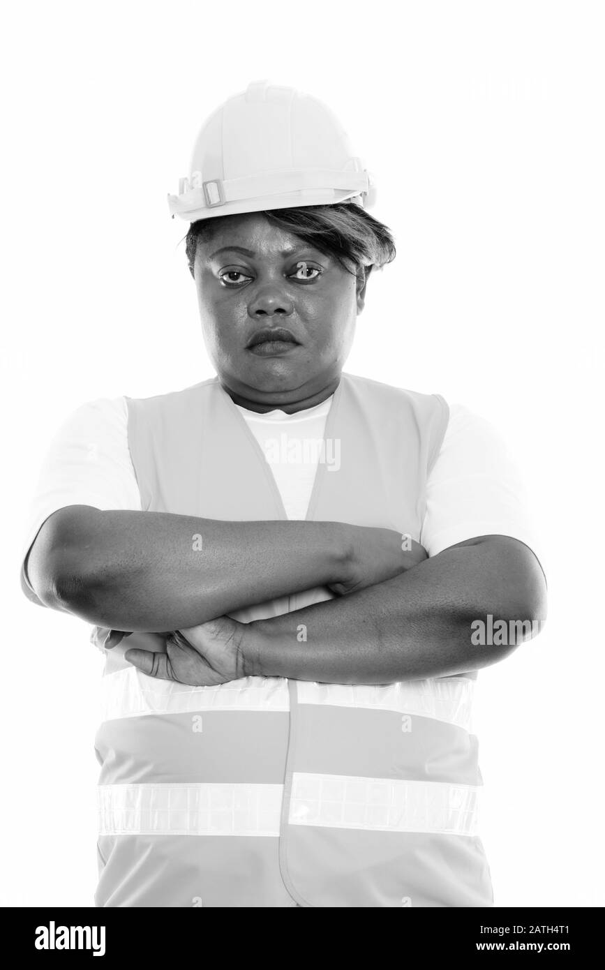 Studio shot of fat black African woman construction worker with arms ...