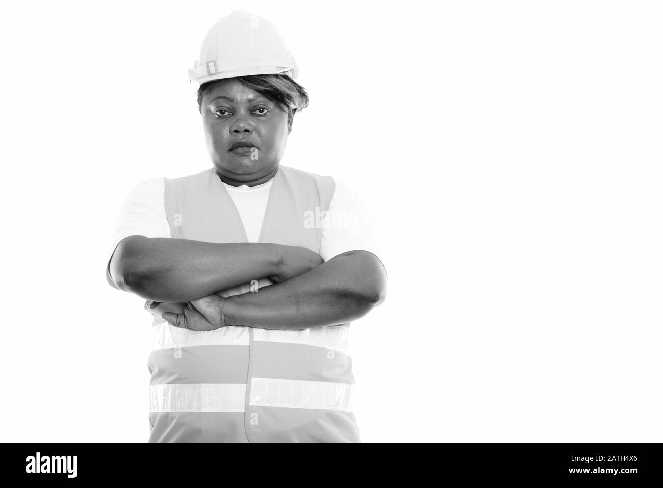 Studio shot of fat black African woman construction worker with arms ...