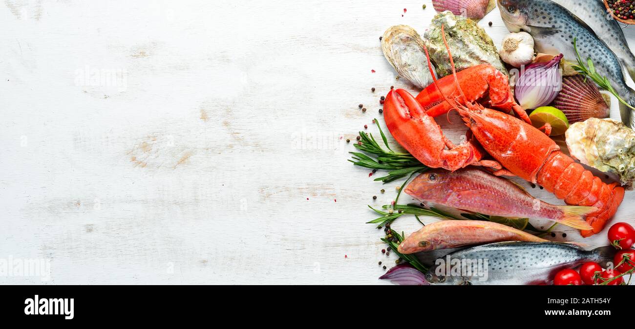 Seafood on a white background. Lobster, fish, shellfish. Top view. Free