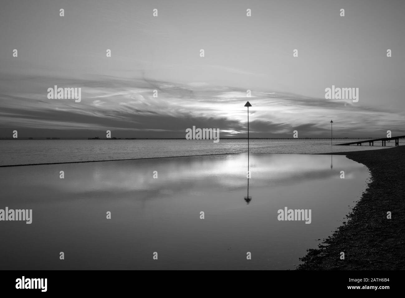 Black and white image of reflections of the sunset at Southend-on-Sea, Essex, England Stock Photo