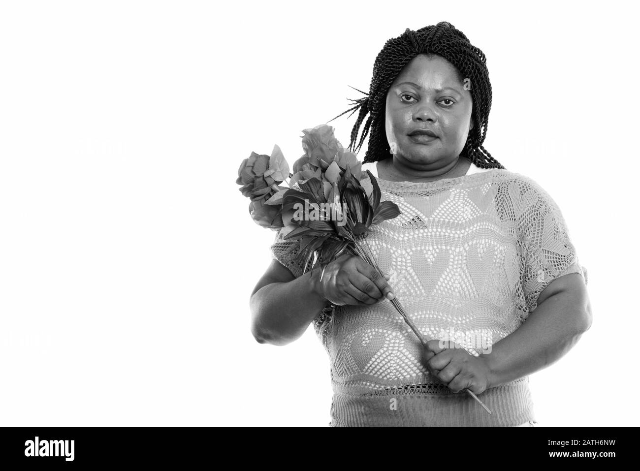 Studio shot of overweight African woman with roses ready for Valentine's day Stock Photo