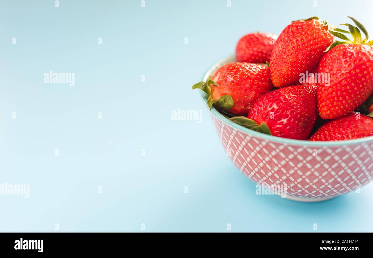 strawberries in a colorful bowl on colorful background Stock Photo - Alamy