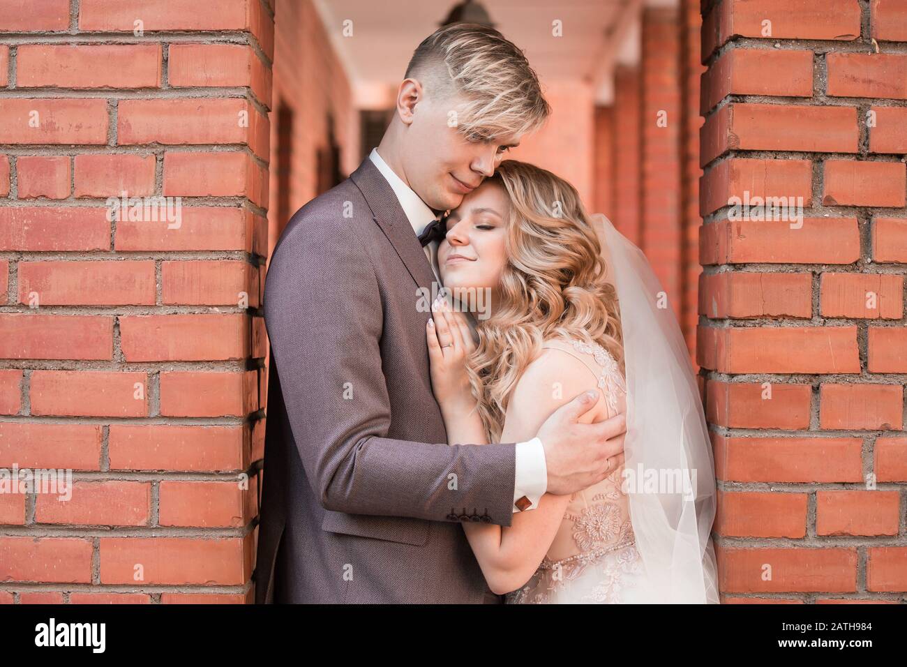happy newlywed couple hugging each other while walking Stock Photo - Alamy
