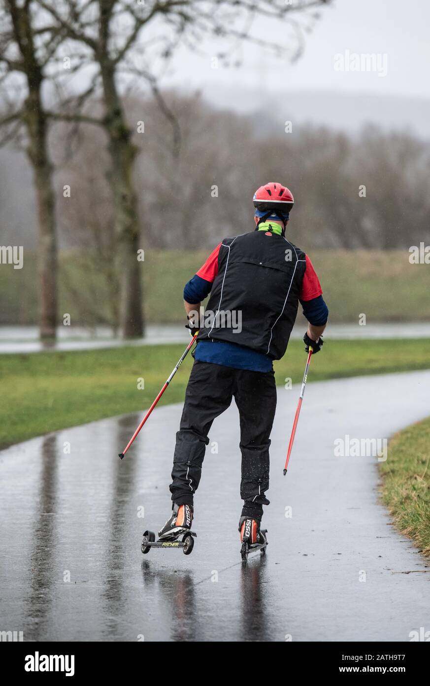 Bochum, Germany. 03rd Feb, 2020. A man with roller skis is on a rain-soaked  road at the Kemnader lake. Credit: Bernd Thissen/dpa/Alamy Live News Stock  Photo - Alamy