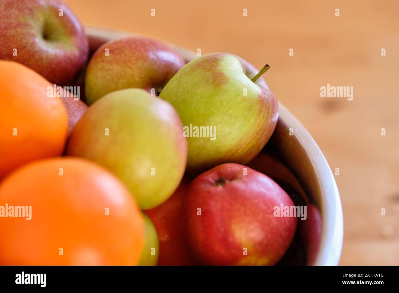 Still life with a heap of fresh and delicious apples and oranges lying in metal bow Stock Photo