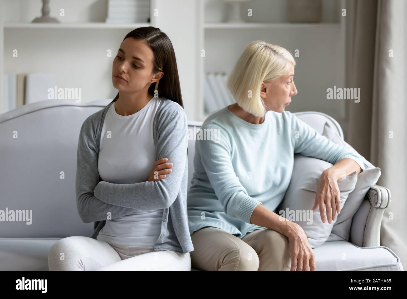Stubborn adult daughter and senior mom avoid talking after fight Stock Photo