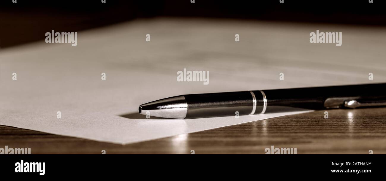 Banner, pen and paper on wooden table, concept contract, submission or last will, copyspace Stock Photo