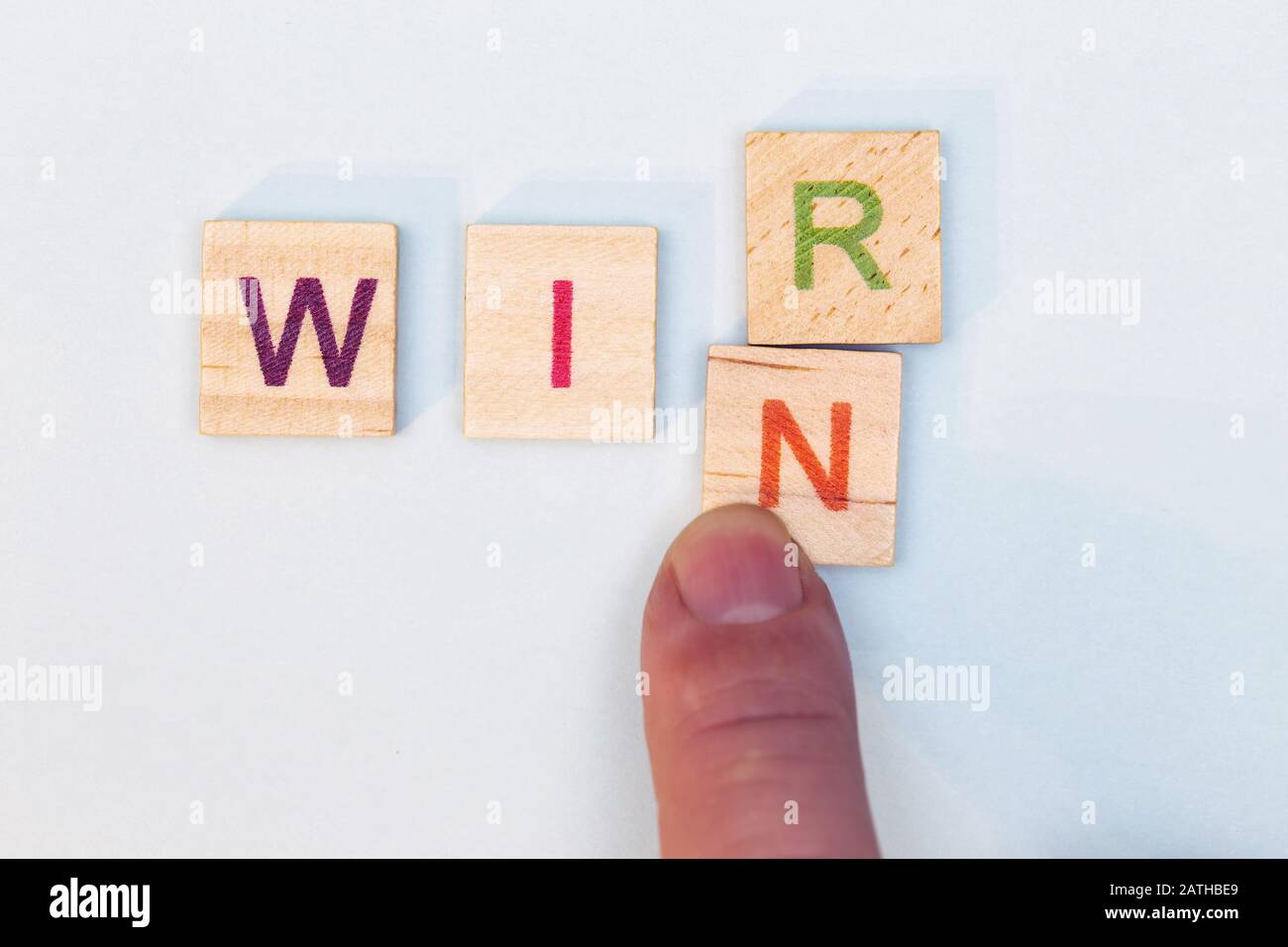 The R in the word we is erased by an N, this results in the word win, wir means in german we Stock Photo
