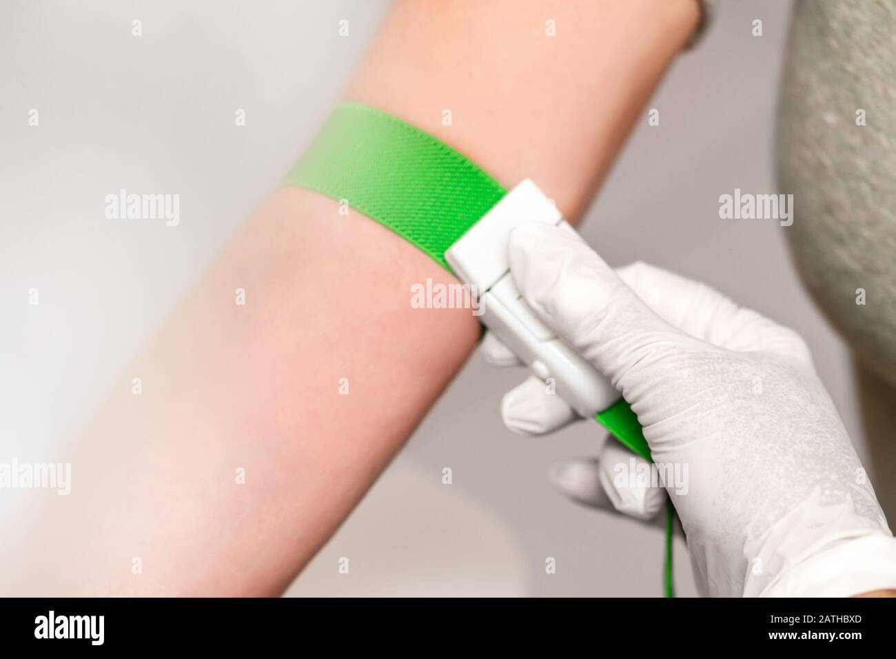 Patient with a tourniquet band on the arm, preparation for blood
