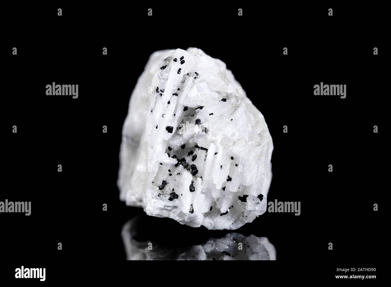 Raw barite or barium mineral stone with tourmaline or schorl in front