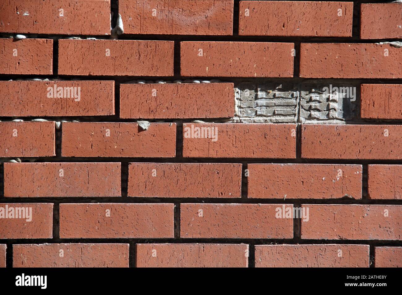 Garden wall with missing a brick Stock Photo
