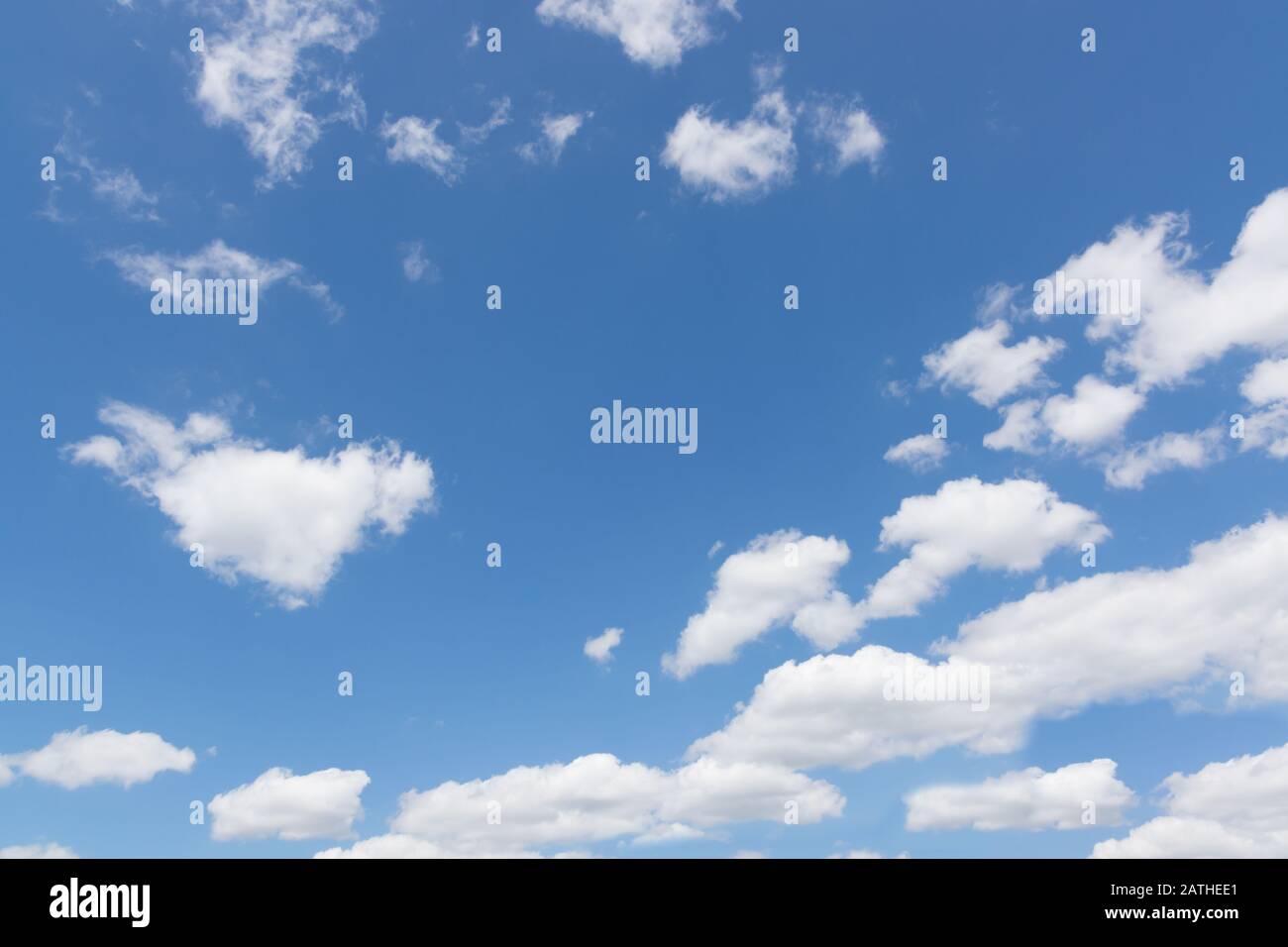 Blue summer sky with fluffy white cumulus clouds Stock Photo