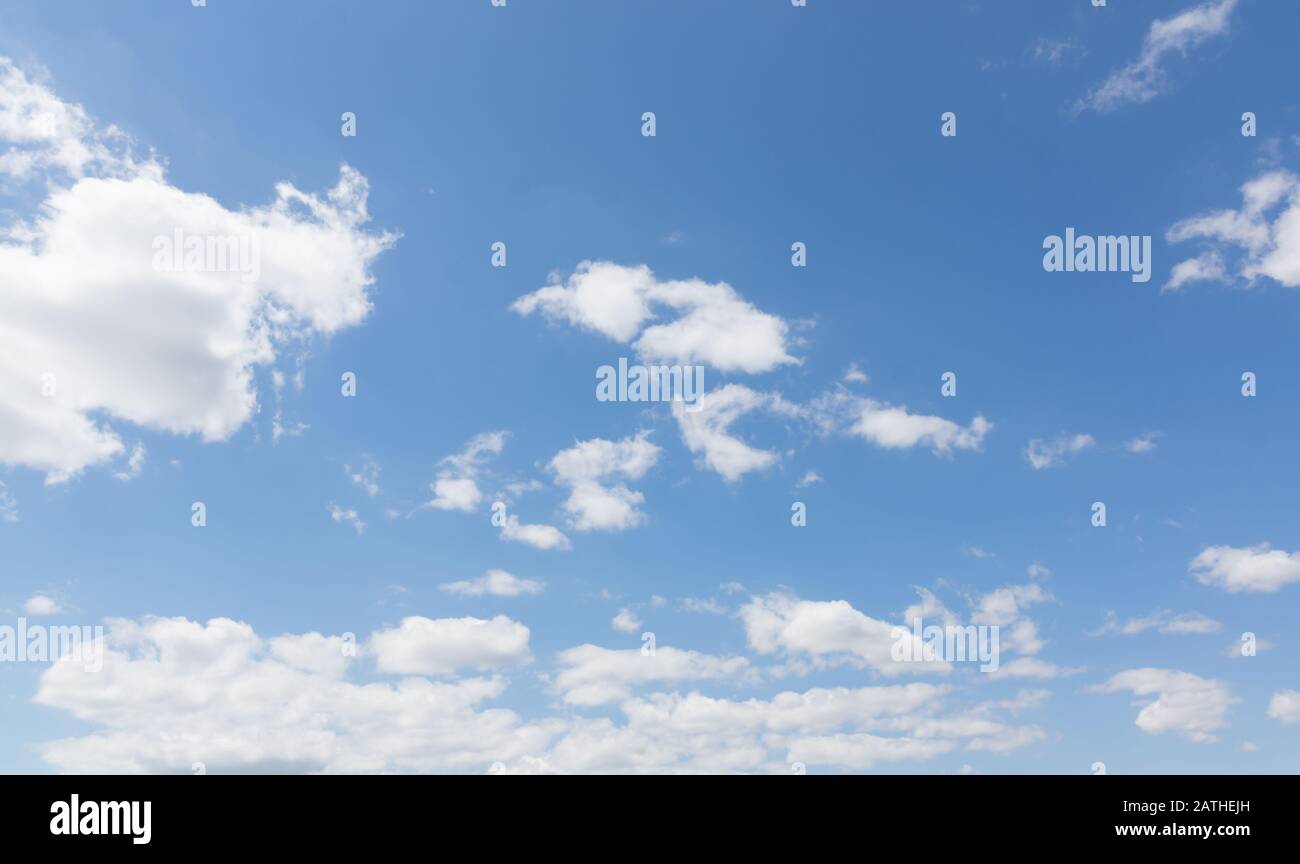 Blue summer sky with fluffy white cumulus clouds Stock Photo