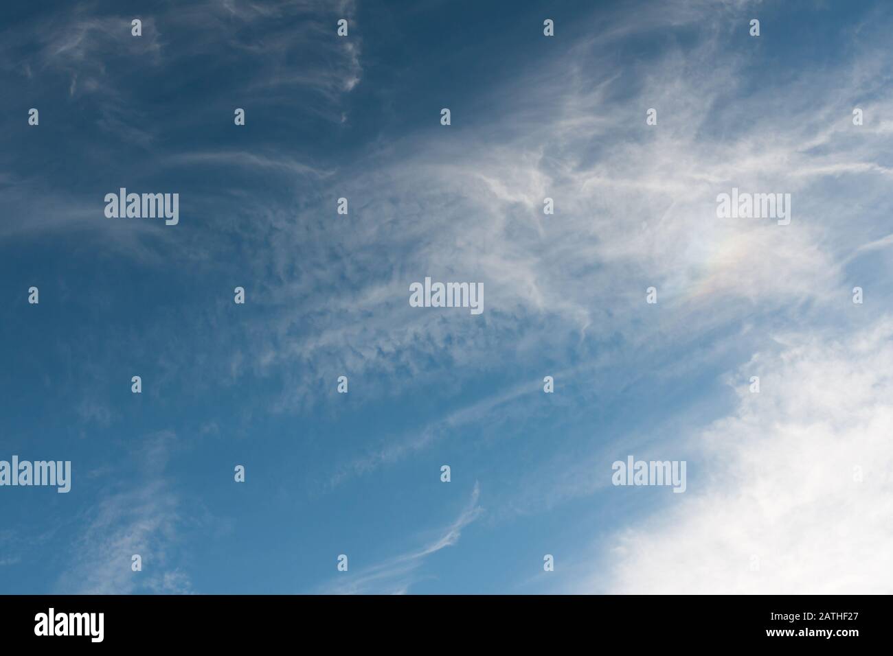 Blue summer sky with whispy white high altitude cirrus clouds Stock Photo