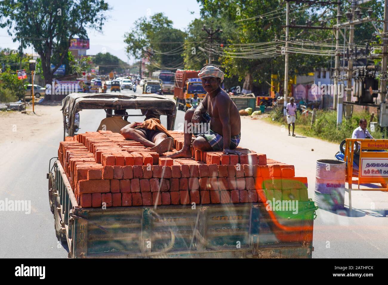 A man sits on a pile of bricks on a lorry. From a series of travel photos in Kerala, South India. Photo date: Sunday, January 12, 2020. Photo: Roger G Stock Photo