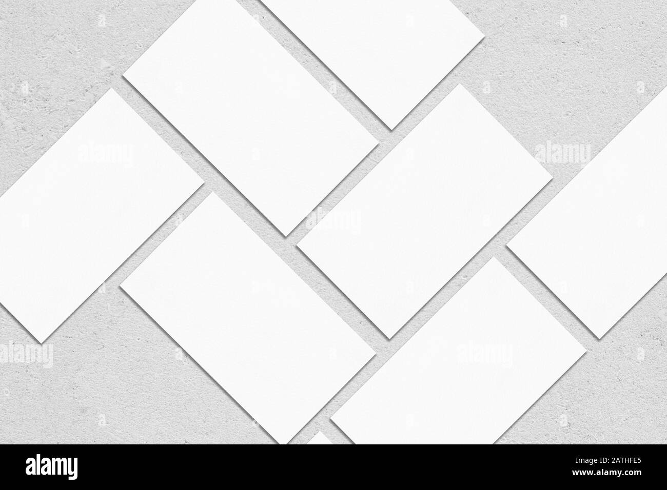 Closeup of empty white rectangle business card mockups lying diagonally ...