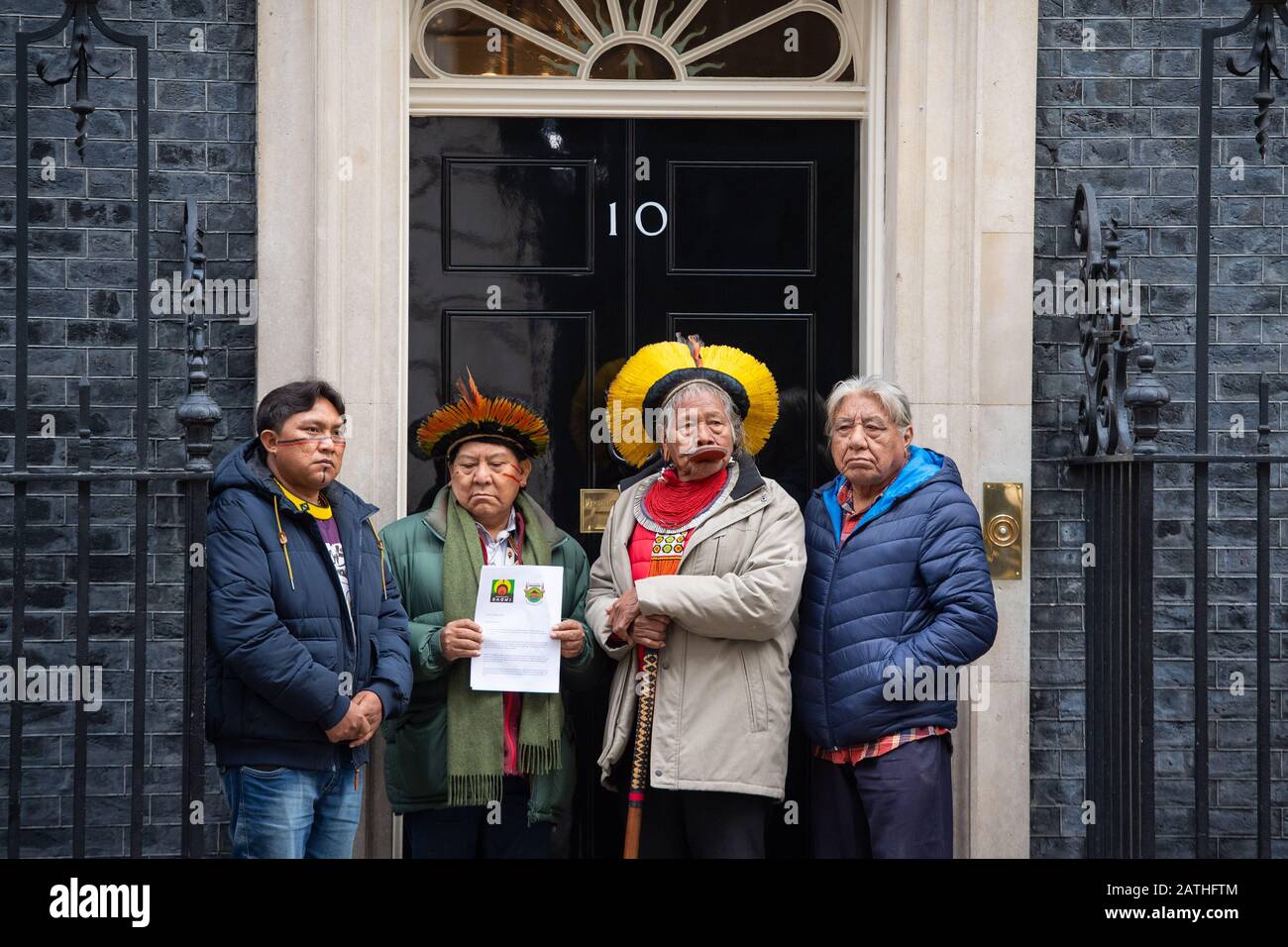 Amazonian indigenous leaders (left to right) Dario Vitorio Kopenawa Yanomami, Davi Kopenawa Yanomami, Raoni Metuktire, and Megaron Txucarramae deliver a letter to 10 Downing Street, London, calling on Prime Minister Boris Johnson to condemn the actions of Brazil's president Jair Bolsonaro in failing to protect indigenous tribes in the Amazon rainforest. Stock Photo